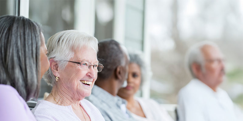 Group of older adults enjoying a conversation together.